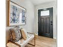 Bright entryway features bench with decor and view of paneled front door at 13586 W Warren Cir, Lakewood, CO 80228