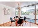 Cozy dining room with modern lighting and sliding glass door to balcony at 1250 N Humboldt St # 202, Denver, CO 80218