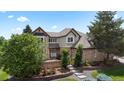 Charming two-story brick home with mature landscaping and inviting curb appeal at 9232 Rockport Ln, Highlands Ranch, CO 80126