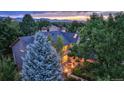 Backyard view, showcasing a patio, landscaping, and mountain views at 3351 Oak St, Wheat Ridge, CO 80033