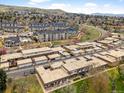 An aerial shot shows a residential neighborhood with well-maintained townhomes and green spaces at 12979 W Ohio Ave, Lakewood, CO 80228