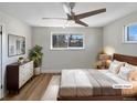 Cozy bedroom with a large window, ceiling fan, and comfortable furnishings at 6650 Depew Ct, Arvada, CO 80003