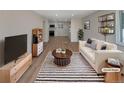 Bright living room featuring stylish decor, a modern rug, and an open layout at 6650 Depew Ct, Arvada, CO 80003