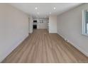 Bright and spacious living room area with sleek flooring and neutral wall paint at 6650 Depew Ct, Arvada, CO 80003