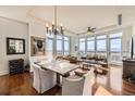 Bright living room with large windows offering views, hardwood floors, and stylish dining area at 5455 Landmark Pl # 413, Greenwood Village, CO 80111