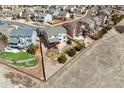 Aerial view displays backyard with well-designed outdoor living space, complemented by lush landscaping and a privacy fence at 1022 Orion Way, Castle Rock, CO 80108