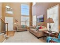 Bright living room with soaring ceilings and large windows that fill the room with natural light at 1022 Orion Way, Castle Rock, CO 80108