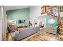 Inviting living room boasts vaulted ceilings, hardwood floors, and ample natural light at 10635 Dexter Dr, Thornton, CO 80233