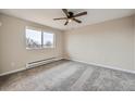 Bright bedroom with new gray carpet and large window offering plenty of natural light at 1152 S Salida Way, Aurora, CO 80017