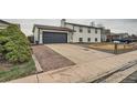 View of the home, driveway, and lawn, offering a glimpse of the property's curb appeal at 1152 S Salida Way, Aurora, CO 80017