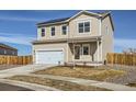 Two-story home boasts neutral siding and two-car garage in a modern suburban neighborhood at 2409 Alto St, Fort Lupton, CO 80621