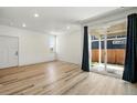 Bright living room with sliding door, light hardwood floors and abundant natural light at 260 E 4Th St, Berthoud, CO 80513