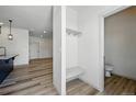 Bright mudroom with a bench and hooks, connecting to a half bathroom and spacious living area at 260 E 4Th St, Berthoud, CO 80513