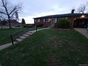 Charming single-story brick home with a well-maintained lawn and an attached one car garage at 12024 W Maryland Dr, Lakewood, CO 80228