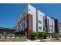 This modern condo building boasts gray and red trim and is surrounded by newly landscaped grounds at 2741 W 28Th Ave # 2, Denver, CO 80211