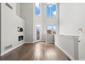 Bright living room featuring soaring ceilings, fireplace, large windows, and modern finishes at 2741 W 28Th Ave # 2, Denver, CO 80211