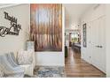 Welcoming foyer showcasing hardwood floors and a view of the kitchen at 749 Bishop Pine Way, Castle Rock, CO 80104