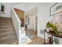 Bright entryway features a staircase and hardwood floors at 749 Bishop Pine Way, Castle Rock, CO 80104