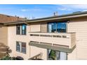 Exterior view of the home shows an outdoor balcony with view of the mountains and city in the distance at 430 Zang St # 4-301, Lakewood, CO 80228