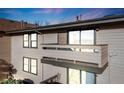 Exterior view of the home shows an outdoor balcony with view of the mountains and city in the distance at 430 Zang St # 4-301, Lakewood, CO 80228