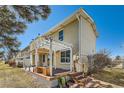 Backyard patio area with awning, lush landscaping, and wooden deck perfect for entertaining at 2446 S Vaughn Way # A, Aurora, CO 80014