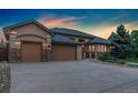 Lovely home boasting a three-car garage, stone accents, and professional landscaping at 3806 S Dawson St, Aurora, CO 80014