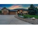 Stunning home at dusk with manicured landscaping and inviting exterior lighting at 3806 S Dawson St, Aurora, CO 80014