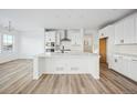 Modern kitchen with white cabinets, quartz countertops, and stainless steel appliances at 3372 N Buchanan Way, Aurora, CO 80019