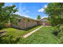Spacious backyard with lush lawn and mature trees, offers a private outdoor space at 6432 Zephyr St, Arvada, CO 80004