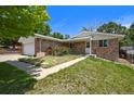 Charming single-Gathering home with brick exterior, a two-car garage, and attractive landscaping at 6432 Zephyr St, Arvada, CO 80004