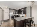 Updated kitchen with stainless steel appliances, modern cabinets, and a breakfast bar at 1121 Albion St # 809, Denver, CO 80220