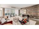 Spacious living room featuring a wood accent wall and a sliding door to a balcony at 1121 Albion St # 809, Denver, CO 80220