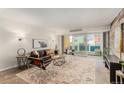 Bright living room with balcony access, a comfortable seating area, and stylish decor at 1121 Albion St # 809, Denver, CO 80220