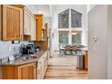 Well-equipped kitchen with granite counters, wood cabinets, stainless steel appliances, and an open layout to the dining area at 180 Emmett Lode Rd, Breckenridge, CO 80424