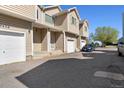 Charming townhome with a private garage, inviting entrance, and well-maintained landscaping at 7234 E 38Th Ave, Denver, CO 80207