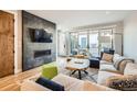 Cozy living room with a modern fireplace, plush sofa, and access to the outdoor area at 3188 W 28Th Ave, Denver, CO 80211