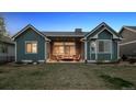 Beautiful backyard of home featuring a covered patio with comfortable seating and serene outdoor space at 2882 Heron Lakes Pkwy, Berthoud, CO 80513
