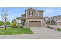 Charming two-story home with a well-manicured lawn, inviting curb appeal, and a two-car garage at 23831 Eagle Bend Ln, Parker, CO 80138