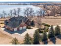 Beautiful aerial view of large brick home with an attached three car garage and mature landscaping at 2366 Shoreside Dr, Berthoud, CO 80513