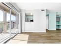 Spacious living area with balcony access, open layout, and stylish flooring at 7423 S Quail Cir # 1533, Littleton, CO 80127