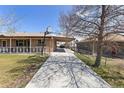 Spacious driveway with covered parking and a basketball hoop, perfect for outdoor activities at 9410 Cedar Ct, Thornton, CO 80229