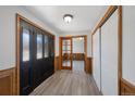 Bright entryway with new flooring, sliding door closets and glass accented French doors at 7746 S Harrison Cir, Centennial, CO 80122