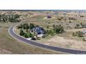 Scenic aerial shot of the home surrounded by mature trees and open fields in a quiet, upscale neighborhood at 9563 Red Primrose St, Franktown, CO 80116