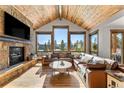Living room with vaulted ceiling, fireplace and mountain views at 1259 Baldy Rd, Breckenridge, CO 80424