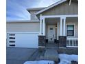 Modern home exterior with covered porch and attached garage at 42976 Colonial Trl, Elizabeth, CO 80107