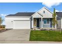 Beautifully designed home featuring a two-car garage, well-manicured lawn and blue and white siding at 761 Muturu Rd, Johnstown, CO 80542