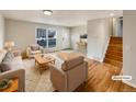 Virtually staged living room with hardwood floors and neutral colors at 10968 Grange Creek Dr, Thornton, CO 80233