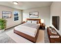 Virtually staged main bedroom with wood bed frame and large TV at 10968 Grange Creek Dr, Thornton, CO 80233