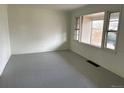 Bright living room with natural light from large windows and painted wood floors at 945 Zenobia St, Denver, CO 80204