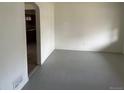 Spacious living room with painted wood floors, flowing into the kitchen at 945 Zenobia St, Denver, CO 80204